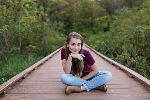 sweet girl showing real personality sitting on bridge picture