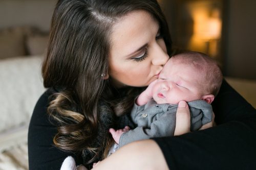 beautiful authentic kiss moment between mom and baby picture