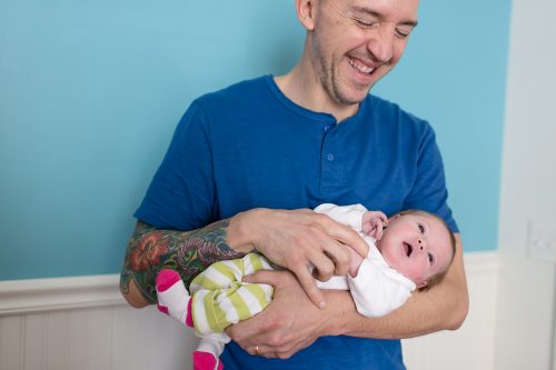 fun happy dad at newborn photo session