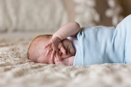 real story newborn session baby covering eyes moment photo