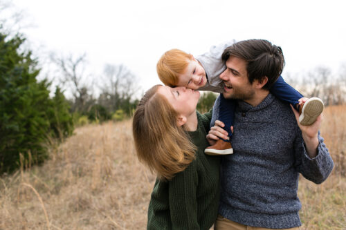 playful sweet family picture in Shawnee field