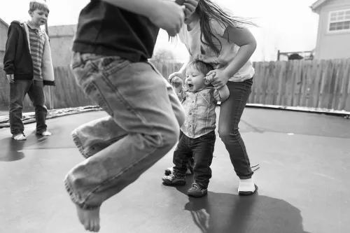KC documentary family photographers photo of kids jumping on trampoline