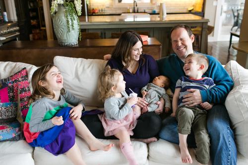 KC genuine happy laughing family during real moment during newborn session