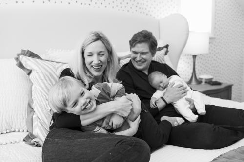 KC lifestyle storytelling newborn session laughing boy on bed