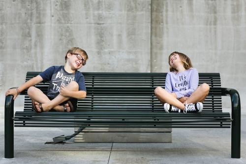 Kansas City authentic family photographers brother sister laughing on bench picture