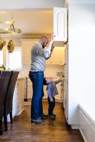 Kansas City day in the life session dad looking in cabinet with son for lunch sweet real photo