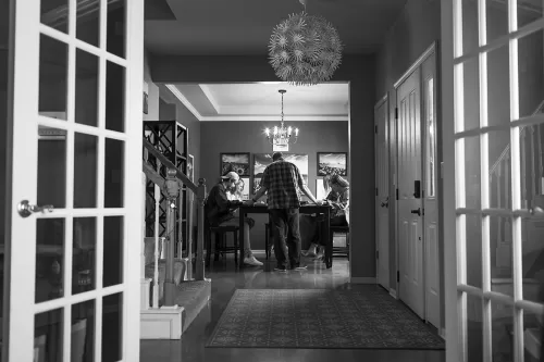 Kansas City documentary photographers real family story family praying at dinner pizza night picture
