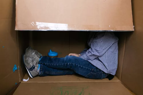 Kansas City family documentary storytellers fun real moment of boy in his box with sippy cup photo