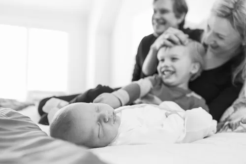 Kansas City storytelling documentary image of famly smiling with newborn photo