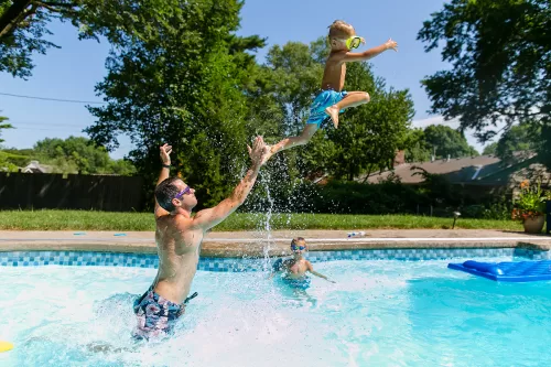 The UNportrait Experience fun photo of dad throwing kid in pool picture