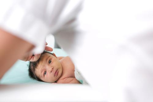 cute baby looking at camera storytelling newborn photo session
