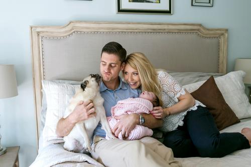 funny storytelling newborn session picture of dog licking dad