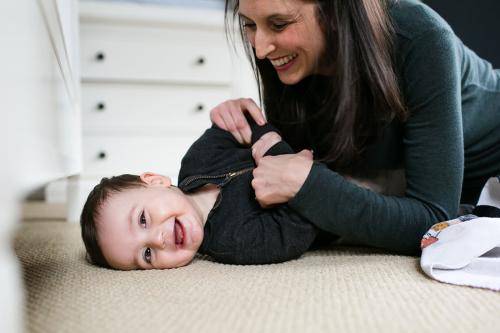 genuine laughter of mom and son during meaningful in home family photo session