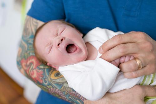 genuine real moment of baby yawning during photoshoot