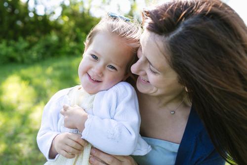 genuine real sweet moment grinning mom and daughter at photo session