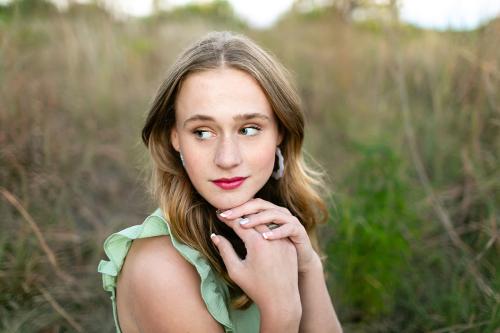 girl senior picture in field