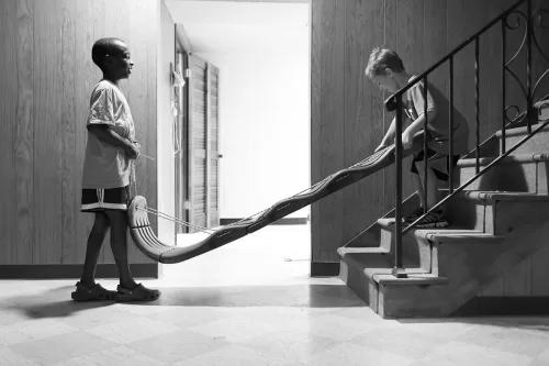 honest fun moment of kids sledding down stairs picture