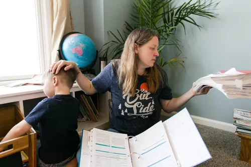 honest real documentary moment mom balancing kids attention and homescholling day in the life session photo