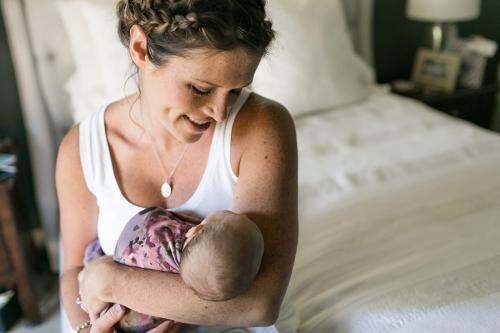 loving authentic moment of mom admiring baby during in-home lifestyle newborn session