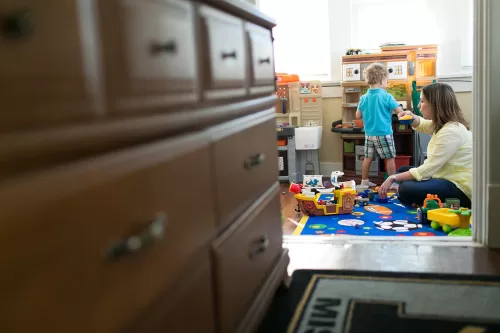 mom playing make believe cooking with son in real family documentary photo