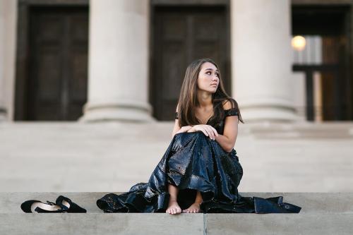relaxed candid of high school senior sitting on steps