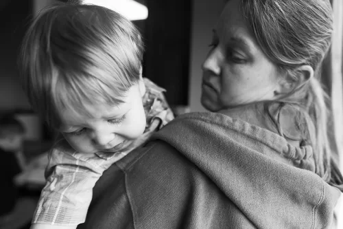 sweet real genuine moment mom holding boy with big crocodile tear Kansas City storytellers