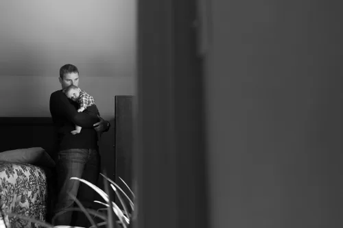 sweet true moment of dad hold little son at home tenderly