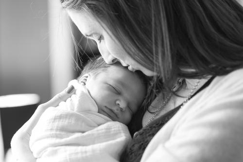 tender genuine loving moment with mother and newborn baby